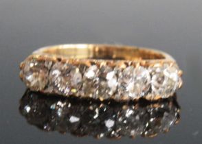 A late 19th century yellow metal five-stone half eternity ring, having five Old European cut
