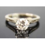 A white metal diamond solitaire ring, featuring a round brilliant cut diamond in a six-claw setting,