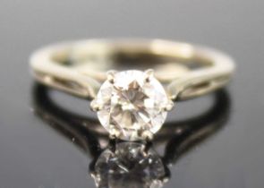 A white metal diamond solitaire ring, featuring a round brilliant cut diamond in a six-claw setting,