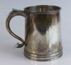 A Georgian style silver tankard, of flaring conical form to a reeded footrim, inscribed Hannover