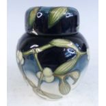 A small contemporary Moorcroft pottery ginger jar and cover in the Christmas Kiss pattern,