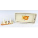 A 1930s Clarice Cliff Capri pattern pottery twin toast rack, typically bright colour painted,