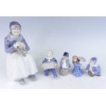 A Royal Copenhagen porcelain figure of an Amager girl sewing designed by Lotte Benter, printed