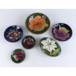 A collection of six Moorcroft pottery items, to include; tube line decorated in the Clematis and