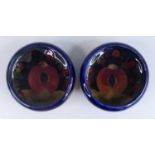 A pair of early 20th century Moorcroft Pomegranate pattern pottery circular footed dishes, each of