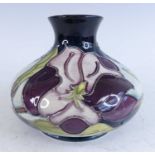 A contemporary Moorcroft pottery squat vase in the Magnolia pattern, of lower bellied form,