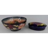 A contemporary Moorcroft footed pottery table bowl in the Hibiscus pattern, underglaze painted and