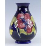 A Moorcroft Hibiscus pattern pottery vase, of baluster form, underglaze painted and tube-line