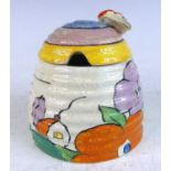 A 1930s Clarice Cliff Poplar pattern pottery honey pot and cover, the cover with handle in the