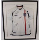 A replica England football shirt, circa 2002, size medium, signed Alan Shearer, Wayne Rooney and one