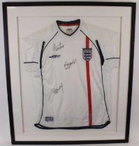 A replica England football shirt, circa 2002, size medium, signed Alan Shearer, Wayne Rooney and one