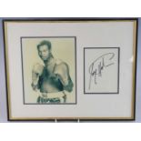 Boxing, Larry Holmes autograph page, mounted next to a 23 x 18cm black and white photograph,