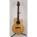 An Eagle Rose six string acoustic guitar, the shaped and mother of pearl inlaid headstock having