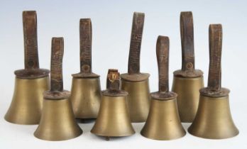 Campanology, a set of eight musical hand bells, each with a leather collar and handle stamped with