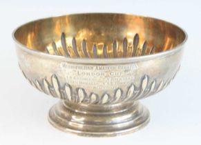 A late Victorian silver trophy bowl, of half-gadrooned circular form, bearing inscription '