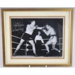 Boxing, Sir Henry Cooper, a 20 x 25cm black and white photograph of Cooper in the ring, signed in