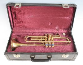 A Boosey and Hawkes model 400 brass trumpet, serial no. 117418, in purple felt lined carry case.