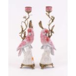 A pair of 20th century porcelain and gilt metal candlesticks, each in the form of a parrot, height