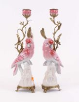 A pair of 20th century porcelain and gilt metal candlesticks, each in the form of a parrot, height