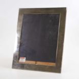 An Elizabeth II silver clad easel photograph frame of rectangular shape, height 29cm