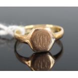 A yellow metal hexagonal signet ring, with worn engraving, size P, gross weight 2.8g, stamped and