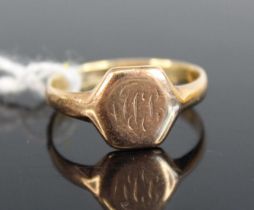 A yellow metal hexagonal signet ring, with worn engraving, size P, gross weight 2.8g, stamped and