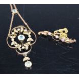 An Edwardian yellow metal blue topaz and seed pearl set open work pendant on finelink neck chain,