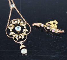 An Edwardian yellow metal blue topaz and seed pearl set open work pendant on finelink neck chain,