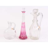 A 19th century cut glass decanter, h.32cm; together with two others (3)