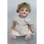 A bisque headed doll, having brown glass eyes, unmarked, 29cm, together with an Armand Marseille