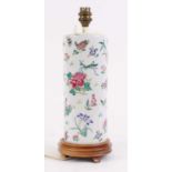 A Chinese porcelain cylinder vase, enamel decorated with flowers, later converted into a table lamp,
