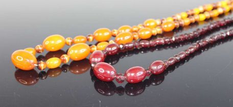 A cherry amber single string necklace, arranged as five graduated barrel beads and further set