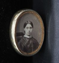 A Victorian mourning pendant, the obverse with photographic portrait of a young woman, the reverse