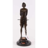 A bronzed figure of a lady, shown holding a staff, upon a black polished hardstone plinth, h.36cm