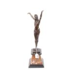 An Art Deco style bronzed figure of a lady, shown with her arms in the air, upon a rouge marble