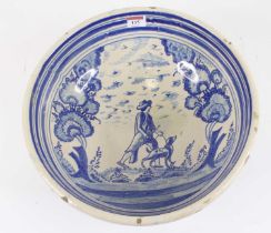 A French blue and white faience bowl, decorated with a man with his dog within a landscape, dia.34.