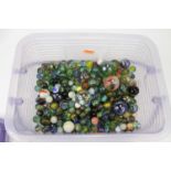 A large collection of coloured glass marbles, varying sizes