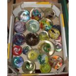 A collection of modern coloured glass paperweights, to include Caithness