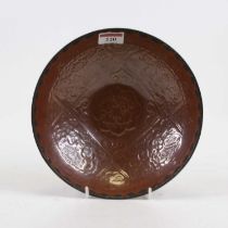 A Chinese brown glazed bowl, having a white metal spear head rim, dia. 21cm Intact.