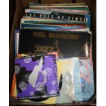 A collection of vintage LPs and singles to include Neil Diamond, Janet Jackson, and Russ Conway
