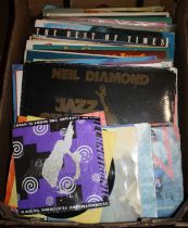 A collection of vintage LPs and singles to include Neil Diamond, Janet Jackson, and Russ Conway