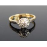 An 18ct gold and platinum diamond circular cluster ring, with 9 brilliant and single cut diamonds,