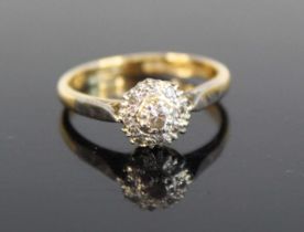 An 18ct gold and platinum diamond circular cluster ring, with 9 brilliant and single cut diamonds,