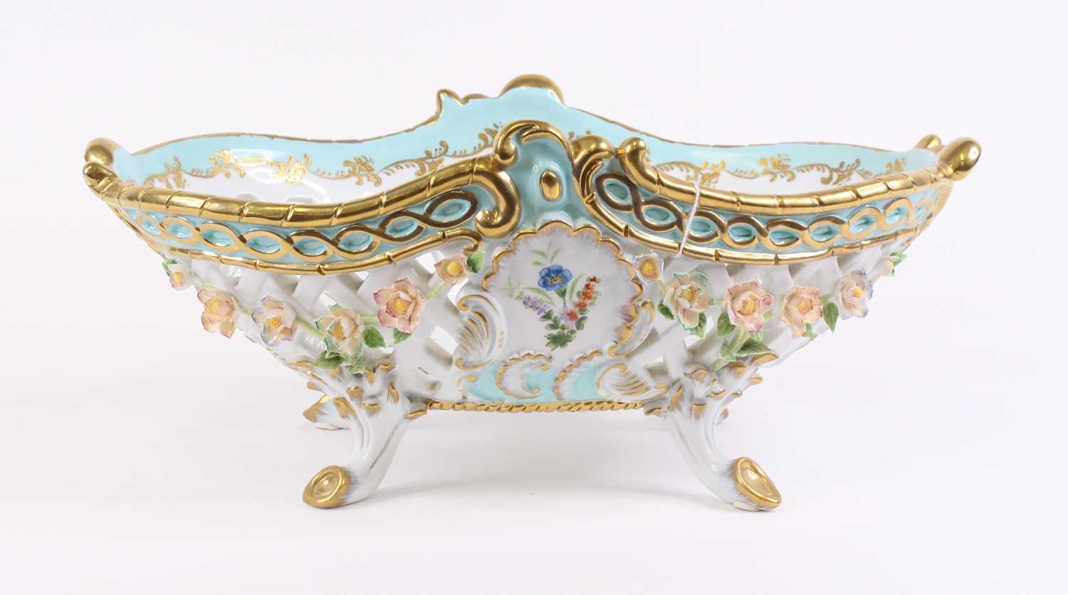A 20th century Dresden porcelain table basket, having floral encrusted decoration, width 44cm Some