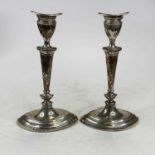 A pair of Victorian silver table candle sticks of elliptical shape, each on a weighted base,