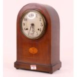 An early 20th century mahogany and boxwood strung 8-day mantel clock, the silvered dial showing