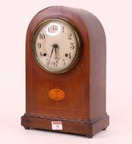 An early 20th century mahogany and boxwood strung 8-day mantel clock, the silvered dial showing