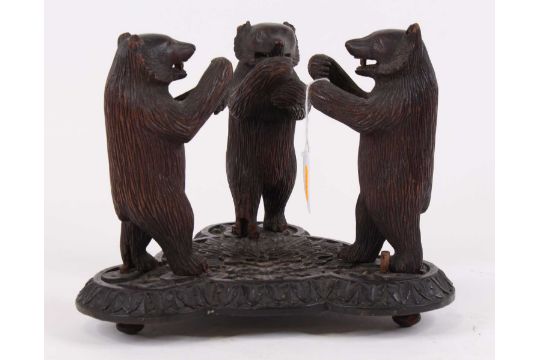 An early 20th century Black Forest carved wood model of three standing bears bears, on shaped - Image 1 of 2