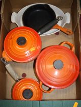 A collection of Le Creuset orange enamel cookware All pieces are quite well used and have