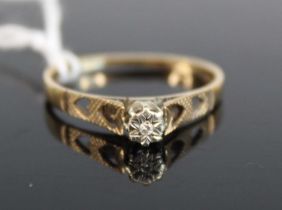 A modern 9ct gold diamond solitaire ring, the illusion set small brilliant weighing approx 0.04ct,